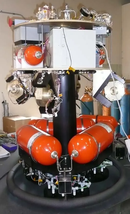 The ASTROS experimental platform, showing the central air-bearing column, VSCMG cluster, and compressed-gas tanks